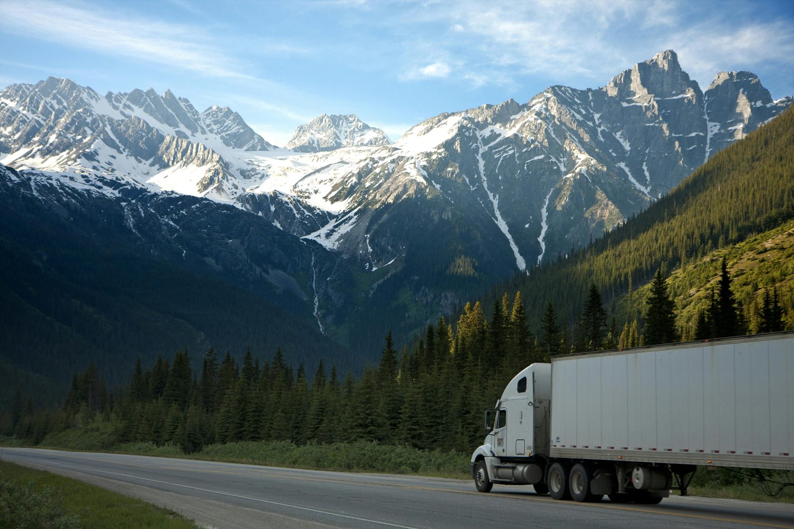 Freight truck hauling a trailer along a mountain highway