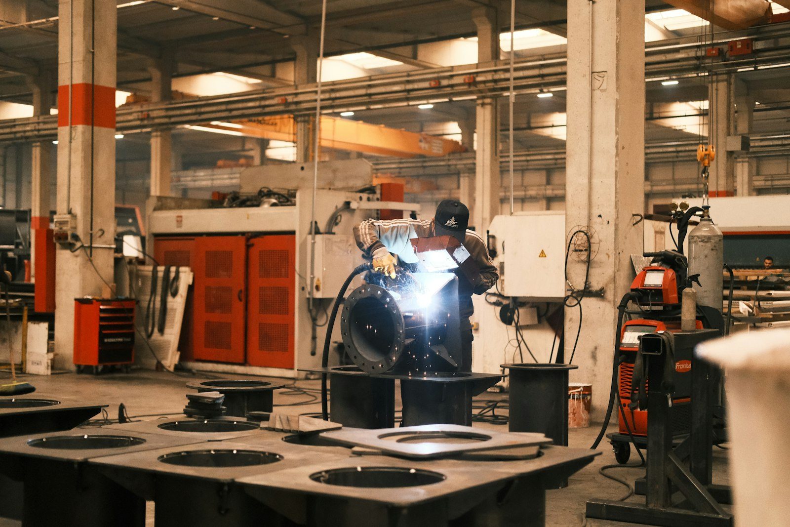 Welder working on a steel fabrication in a workshop