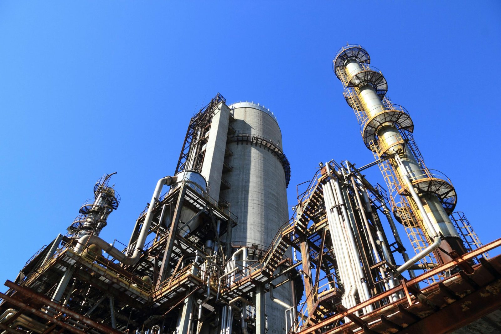Processing towers at an oil and gas facility against a clear sky