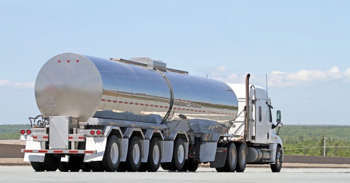Stainless steel tanker trailer pulled by a semi truck