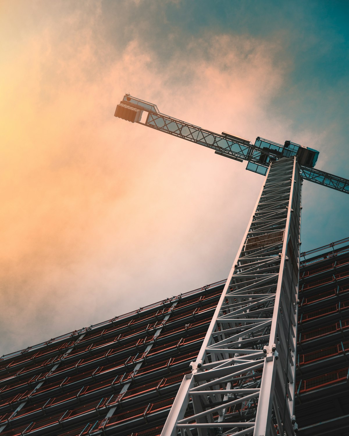 Tower crane over a building under construction at dusk