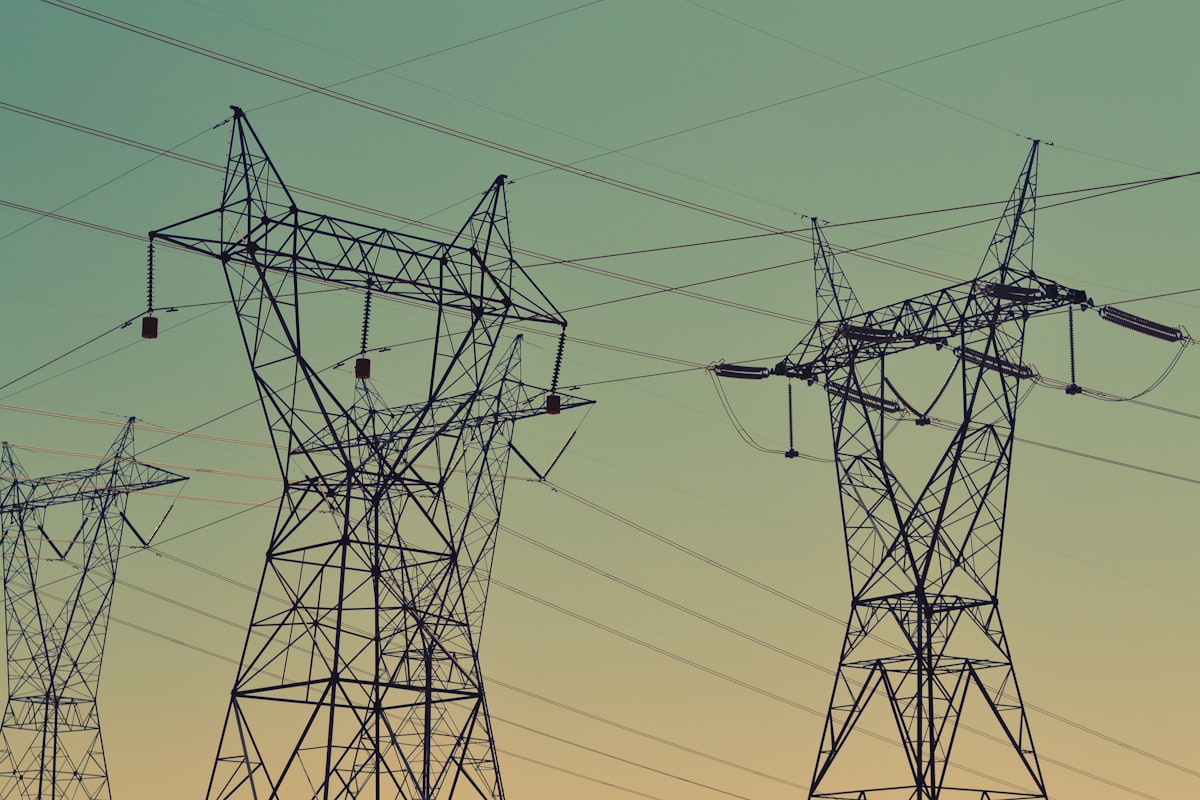 High-voltage transmission towers against an evening sky