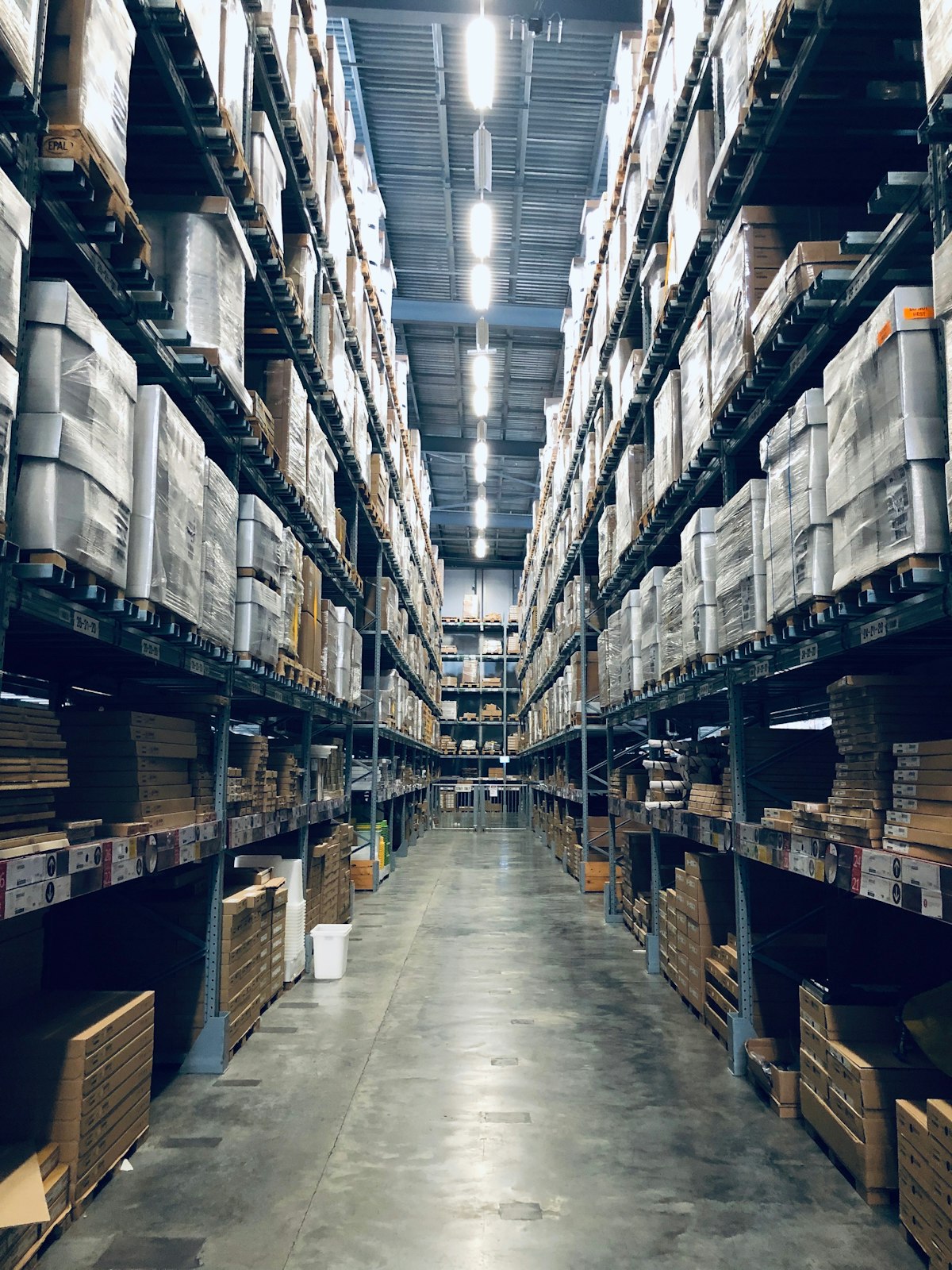Tall stocked racking aisle inside a distribution warehouse